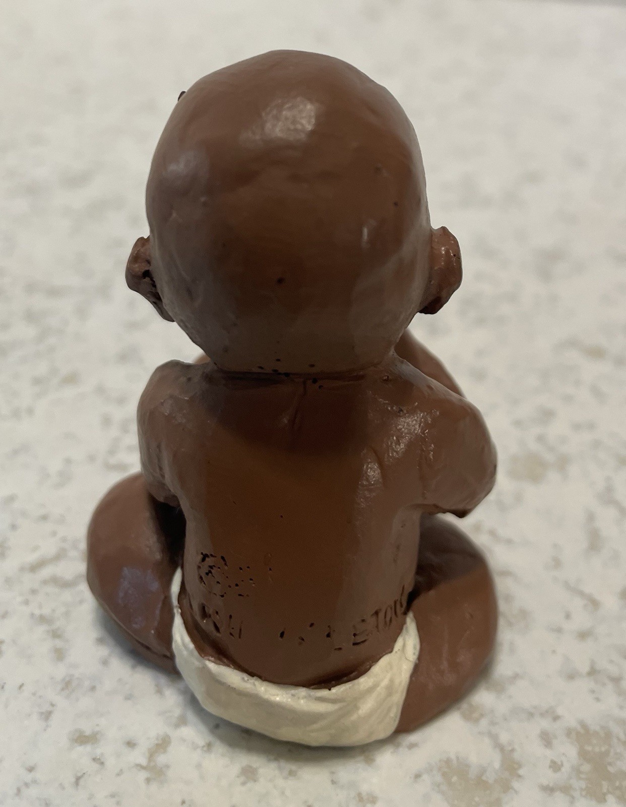 Baby With Coke Bottle 2 1/2” Tall Handcrafted, Signed Figurine