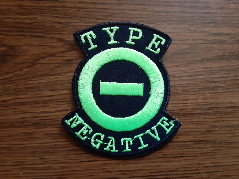 TYPE OF NEGATIVE, IRON ON GREEN EMBROIDERED PATCH