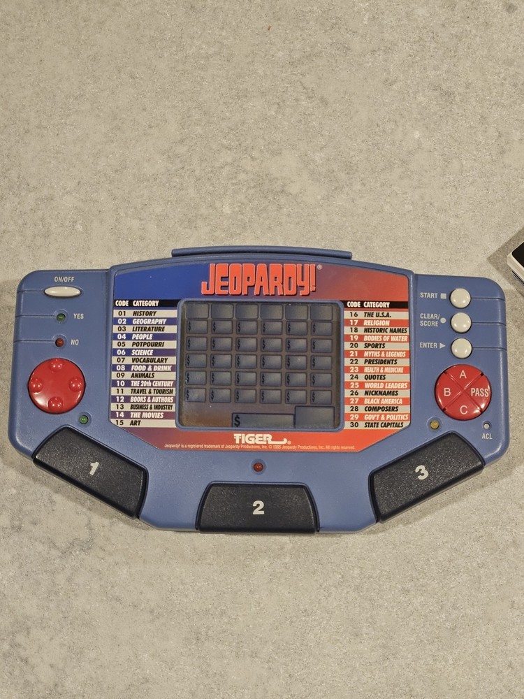 Tiger Electronics Jeopardy Hand Held Game 1995 with Answer Question Book