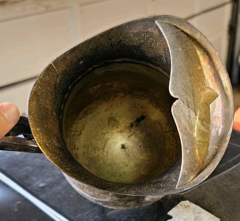 This vintage collectible is a silver-plated, footed pitcher