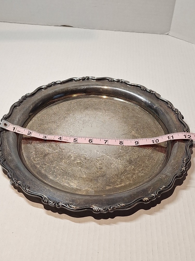 Oneida silver serving platter. Two lions mark pattern. 12” diameter.