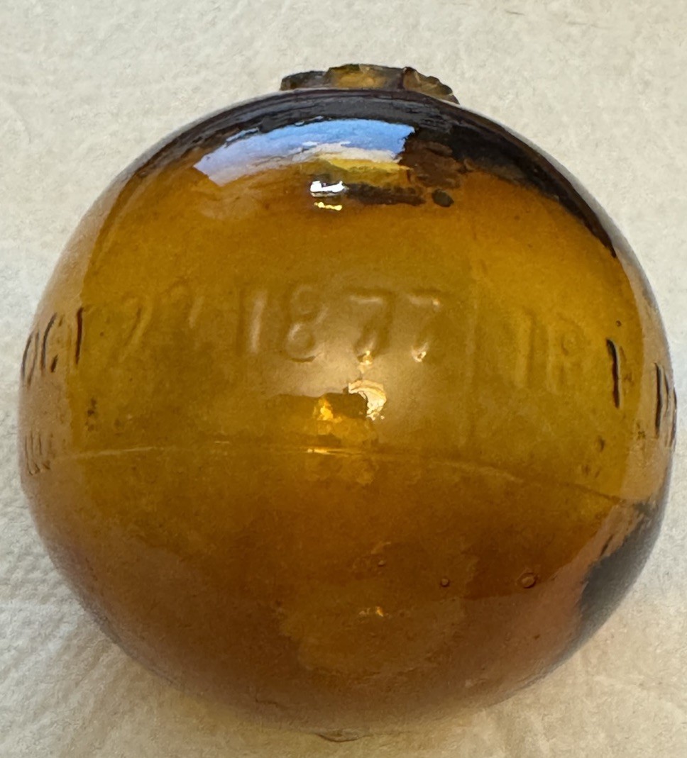 SUPER RARE ANTIQUE IRA PAINE’S FILLED AMBER GLASS TARGET/SHOOTING BALL, 2.5”