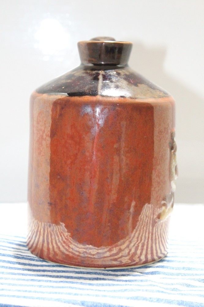 Brown Jug with Handle and a Chicken Design
