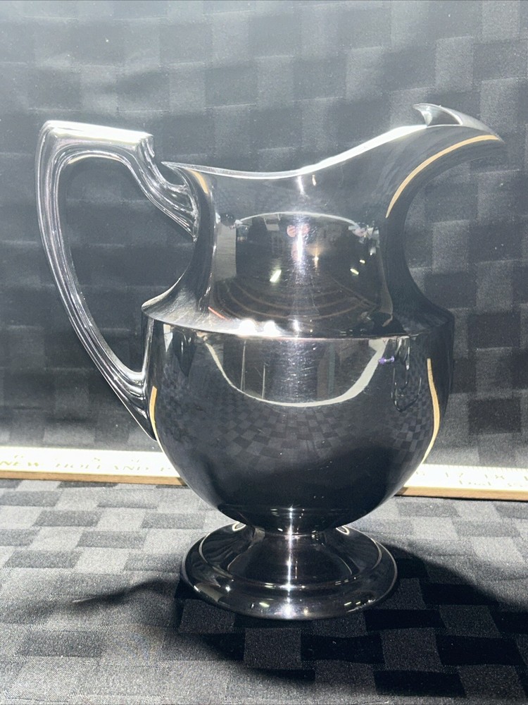 Vintage crescent silver plated water pitcher with ice lip