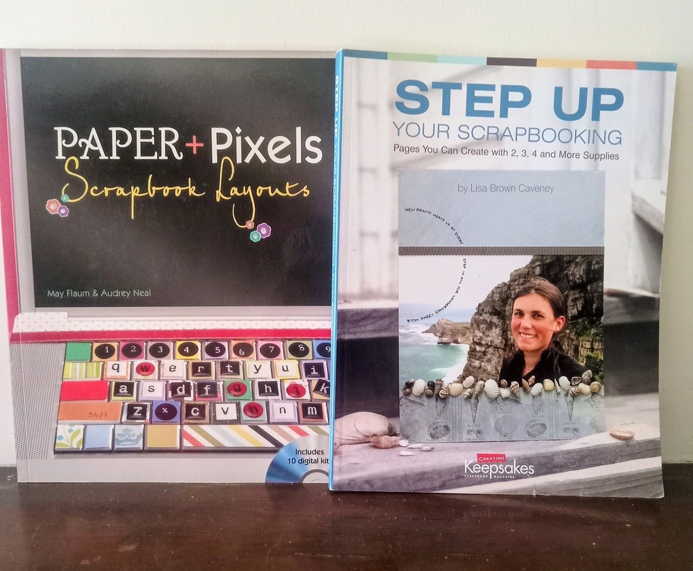 two scrapbooking  instructional/layout books. one has program CD included.