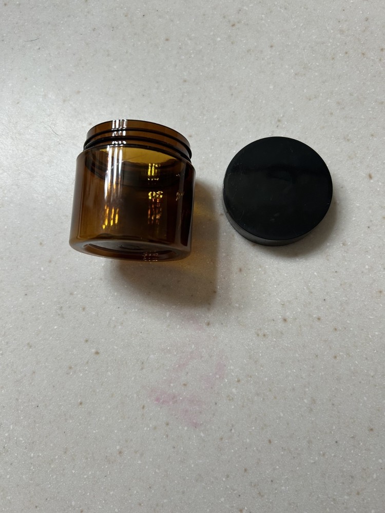 Small brown translucent plastic jars with lids