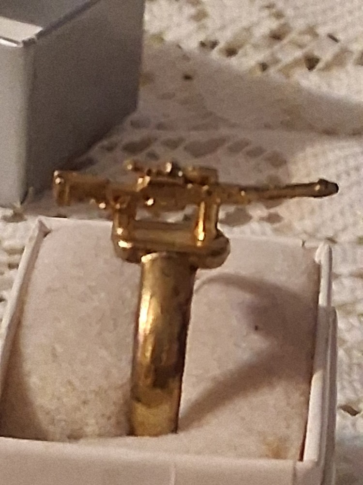 Early 40's to late 50's gold gun ring. Military based