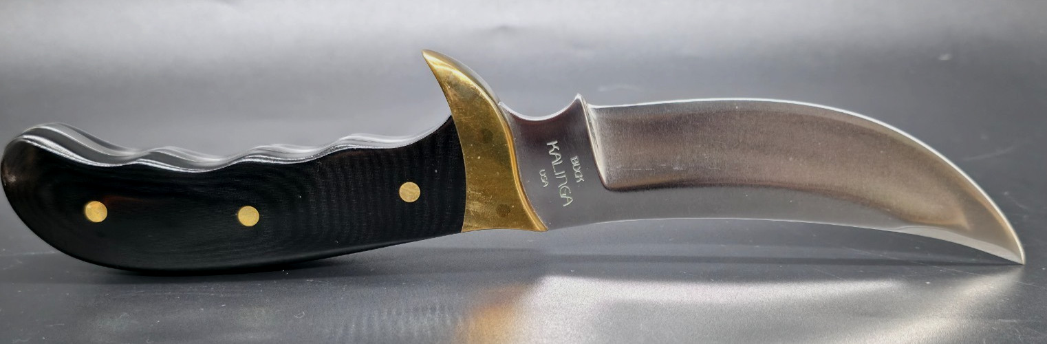 Buck Kalinga knife with black handle and brown leather sheath