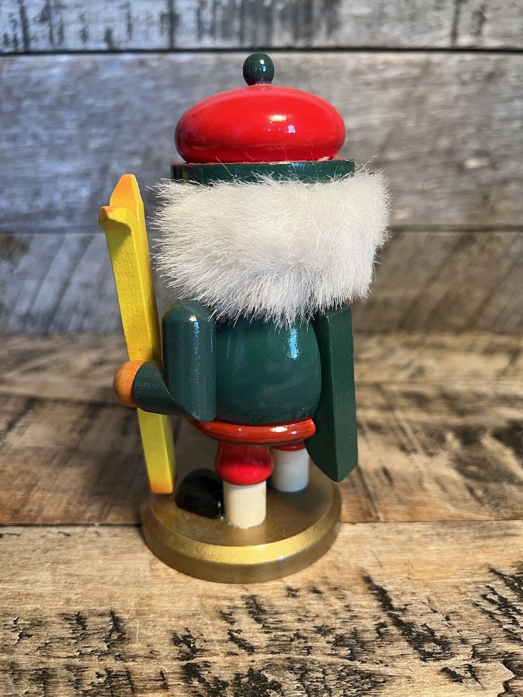 Vintage Christmas Nutcracker Holding Skies