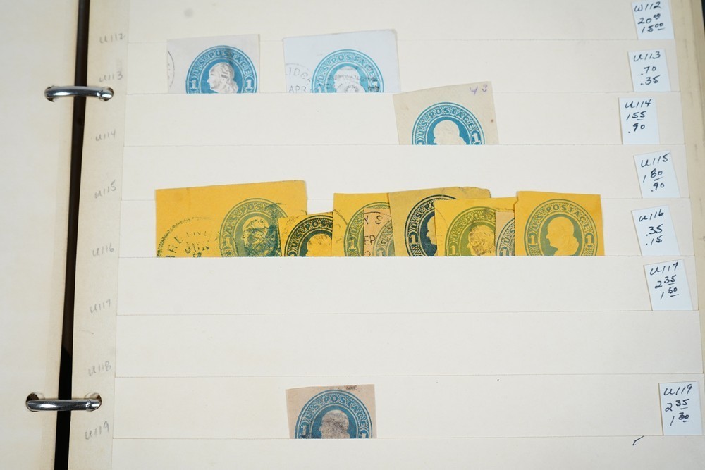 US COLLECTION OF 1,200+ STATIONERY CUT SQUARE STAMPS STORED IN STOCKBOOK