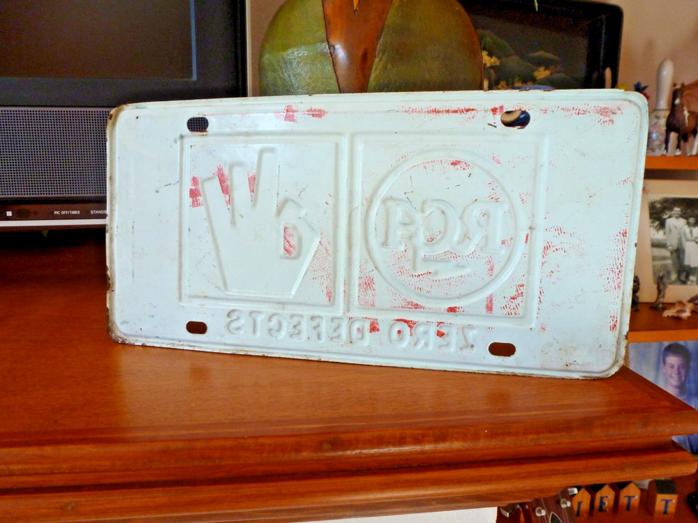 Embossed RCA Zero Defects License Plate from 1964
