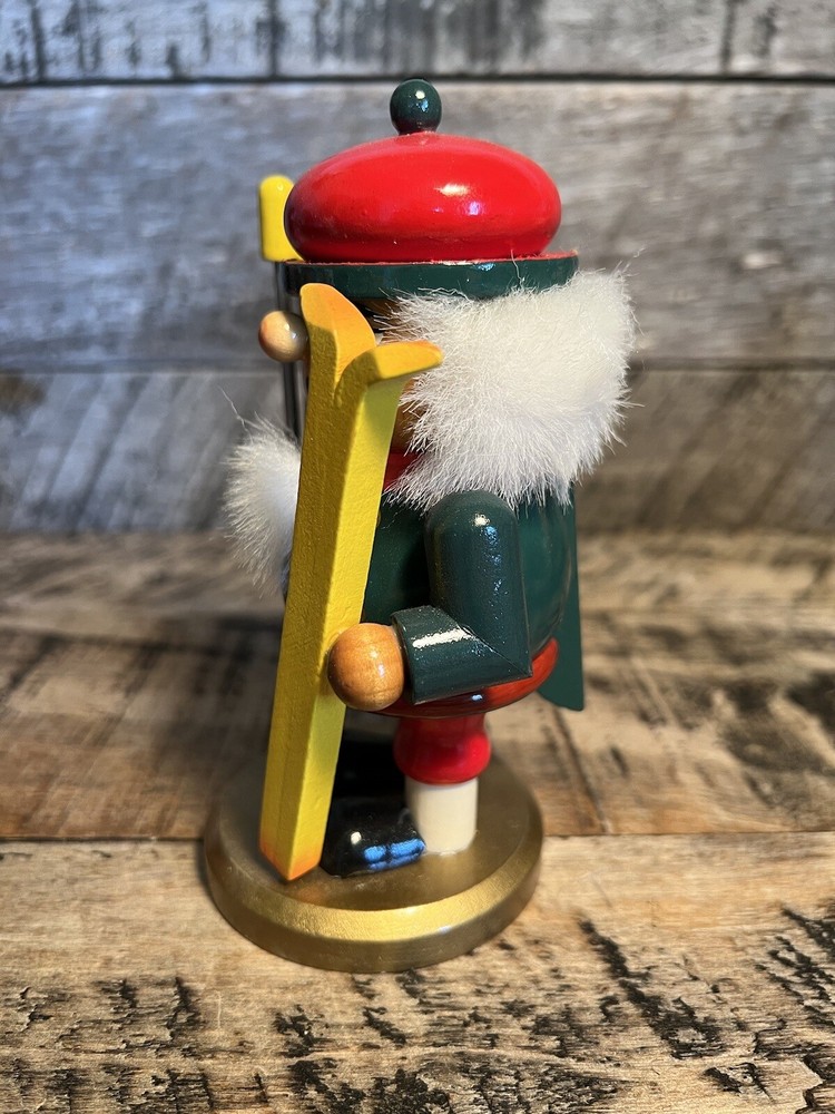 Vintage Christmas Nutcracker Holding Skies