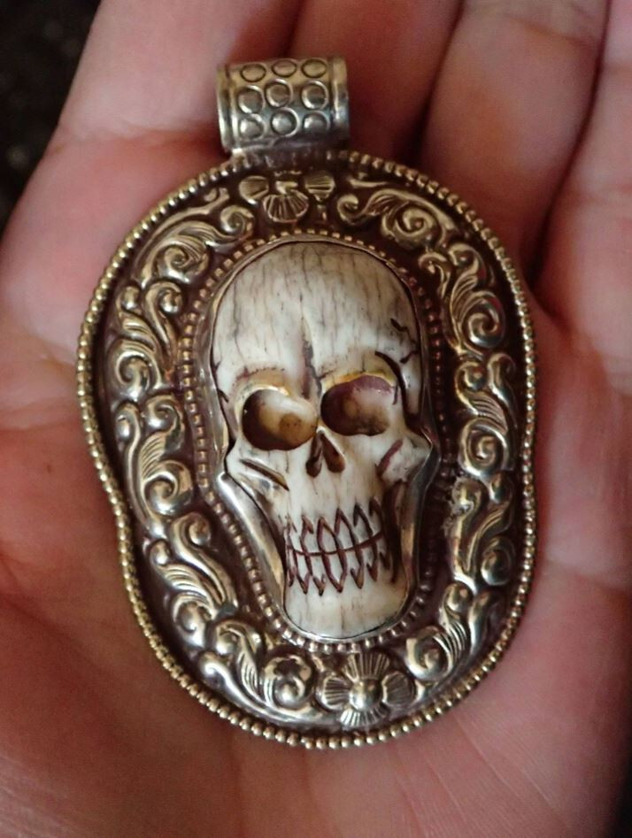 Carved  skull face in Tibetan silver .