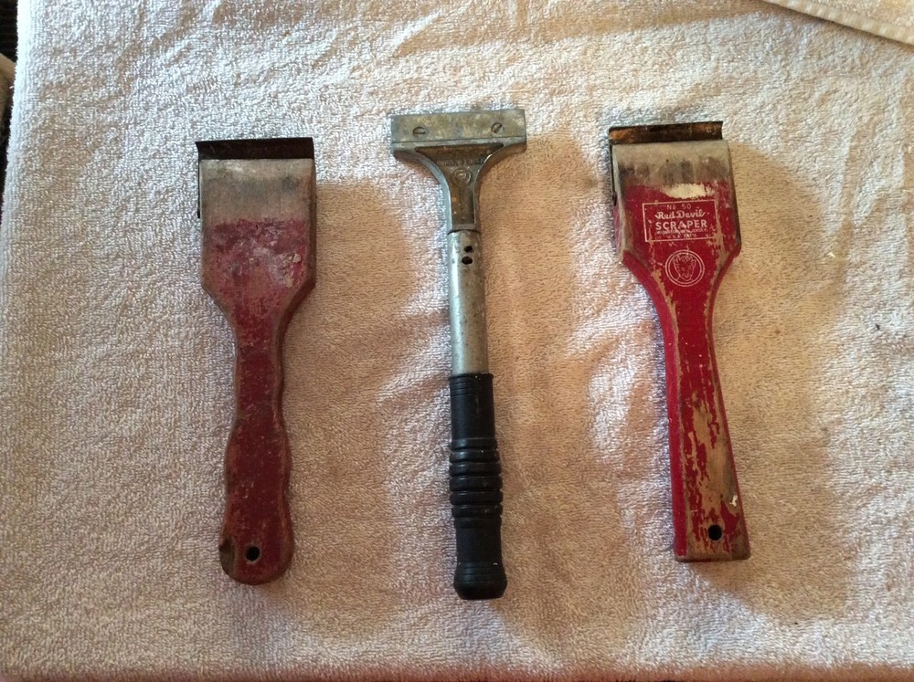 Three red Devil scraper tools
