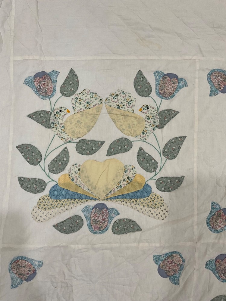 Vintage handmade quilt with birds