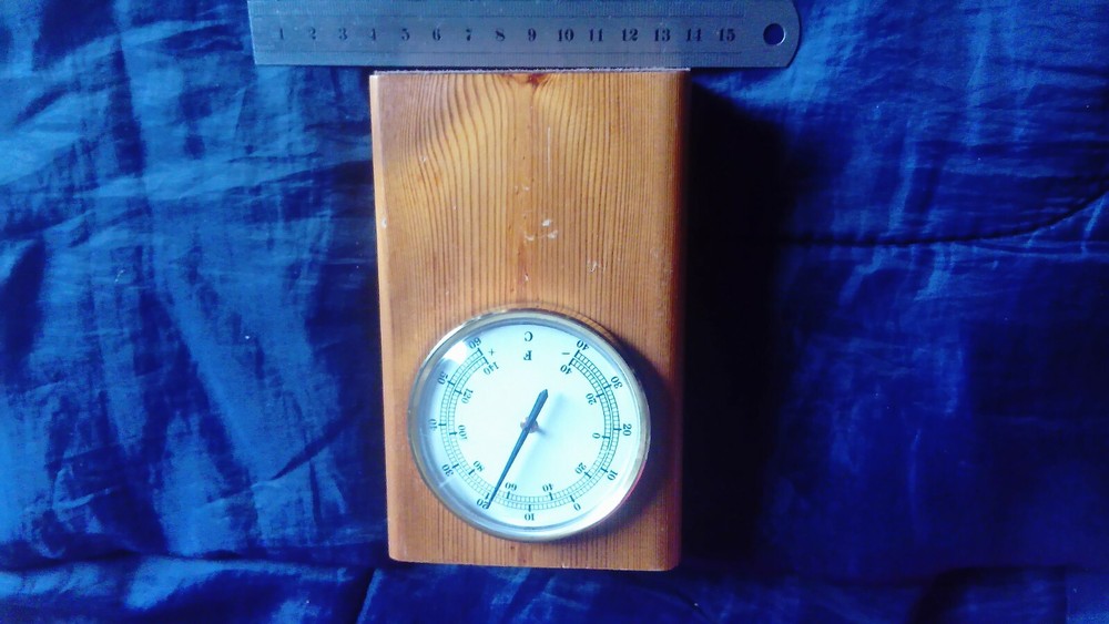 Vintage thermometer mounted in solid wood