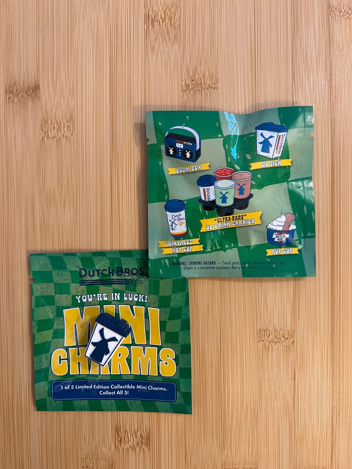 Dutch Bros March 2026 Mini Charms.  1 Dutch Bros Sign and  1 Sealed Mystery Bag.