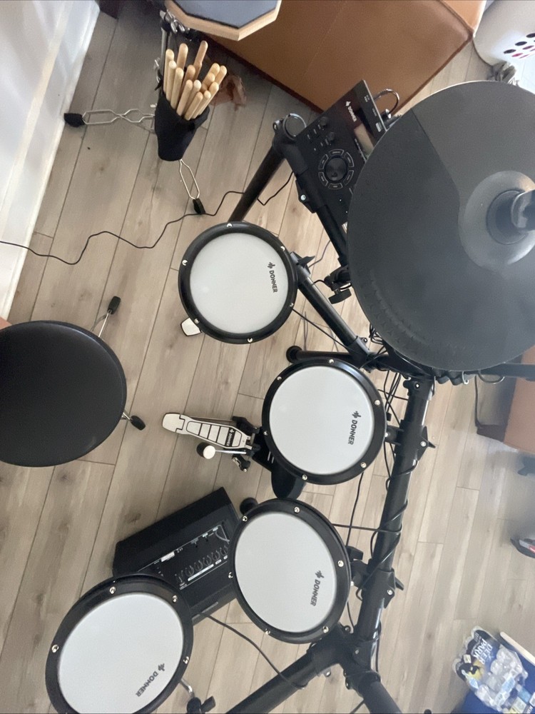 Donner DED-200 Drum set with amplifier, drumsticks, table, and seat.