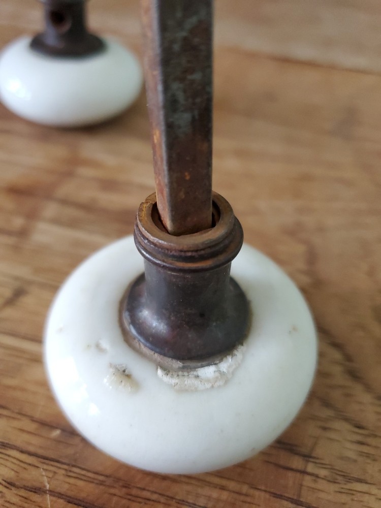 Two Antique Victorian White Porcelain Door Knobs With Iron Stem