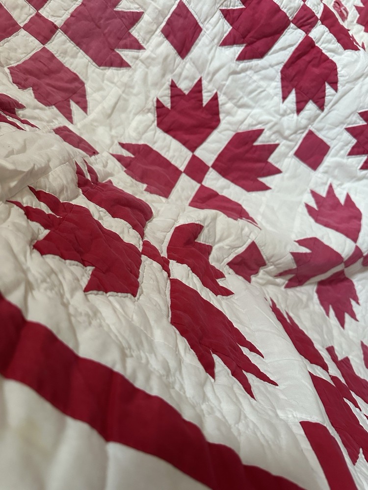 Cutters handmade red and white "Bear Paw" pattern quilt.