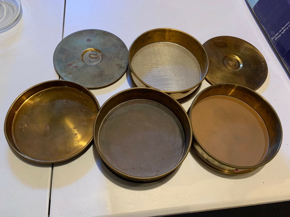 Three U.S. Standard Sieves, stackable, 325, 65, and 35 mesh, with lids, tray