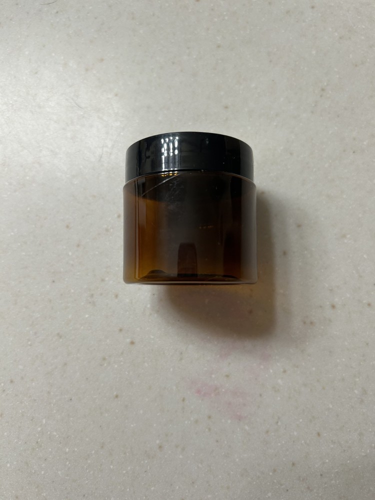 Small brown translucent plastic jars with lids