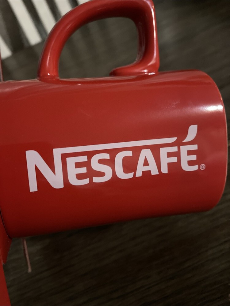 Mug Coffee & 3 packets Inside Dark Roast Nescafe Clasico.