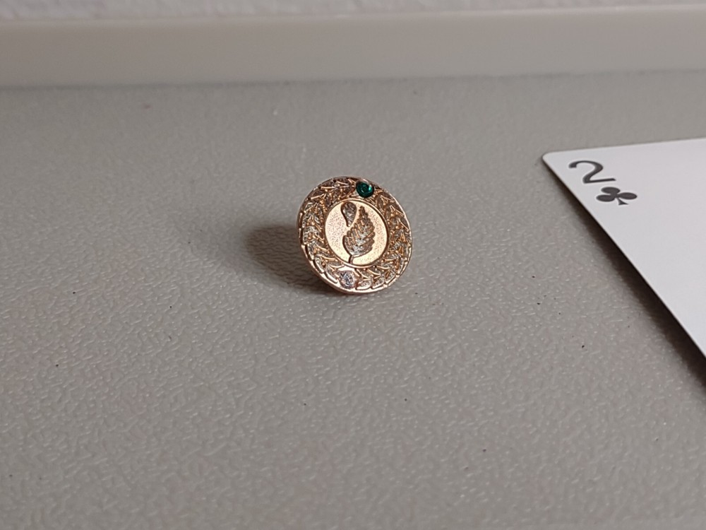 Round Gold Tone And Green Leaf Pin