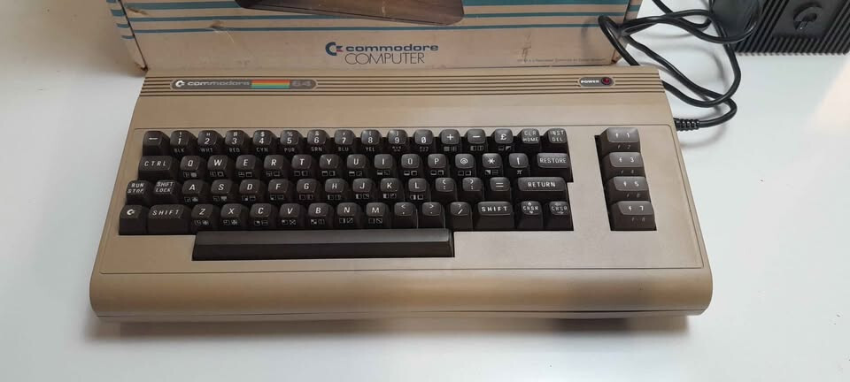 Vintage Commodore 64 computer in box, manuals and programs package