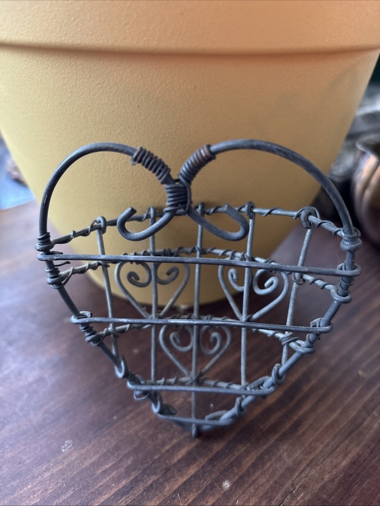 rustic, heart-shaped wire basket with scrollwork details.