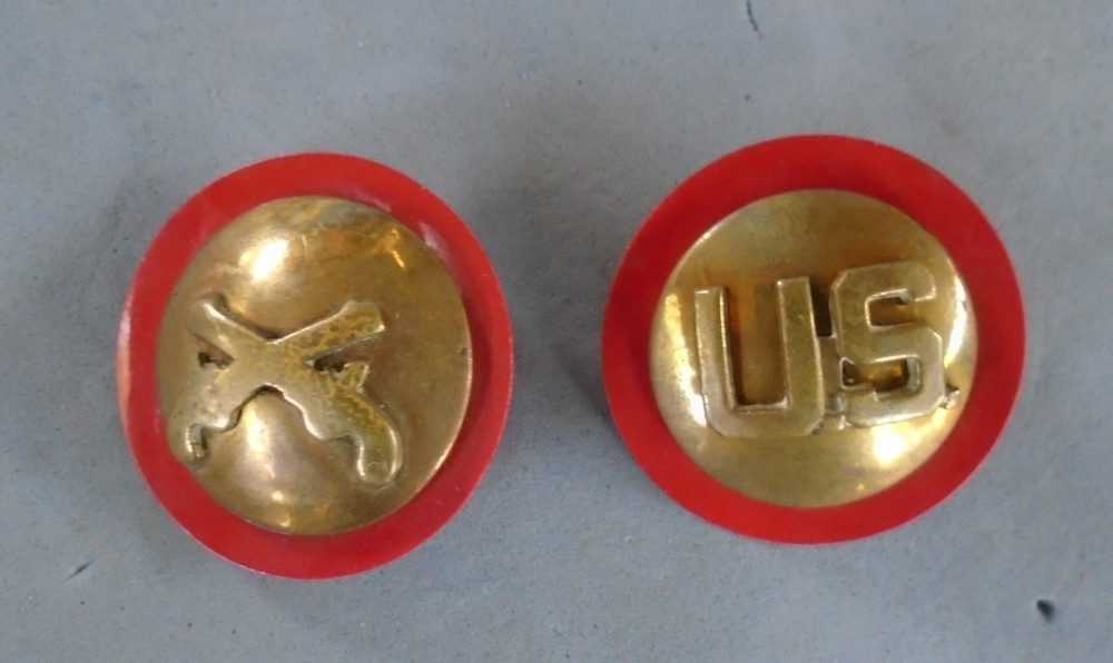 MP and US collar discs on red plastic