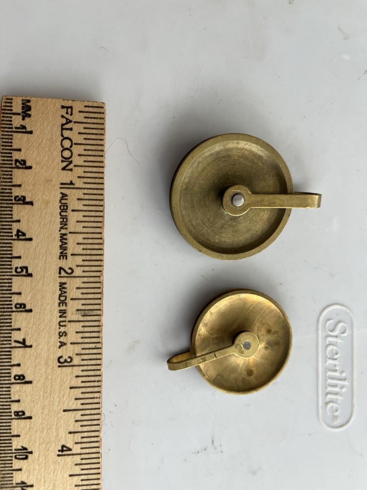 One large and one small Original E Howard Pulley Wheels.