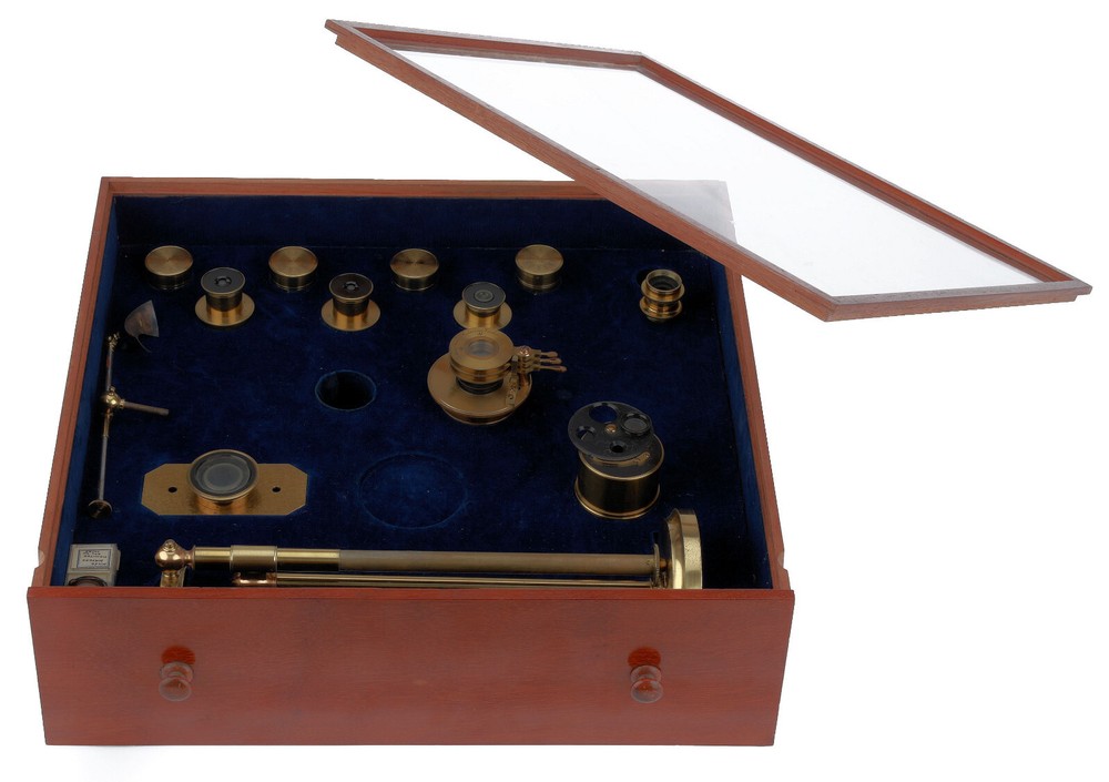 Very large binocular microscope in case with accessories.