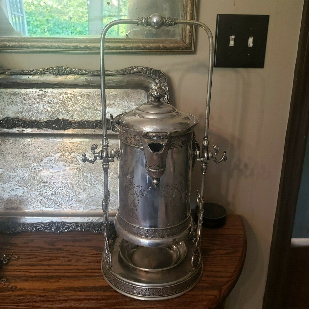 James W. Tuft silverplated tilting water pitcher. 20" tall. 