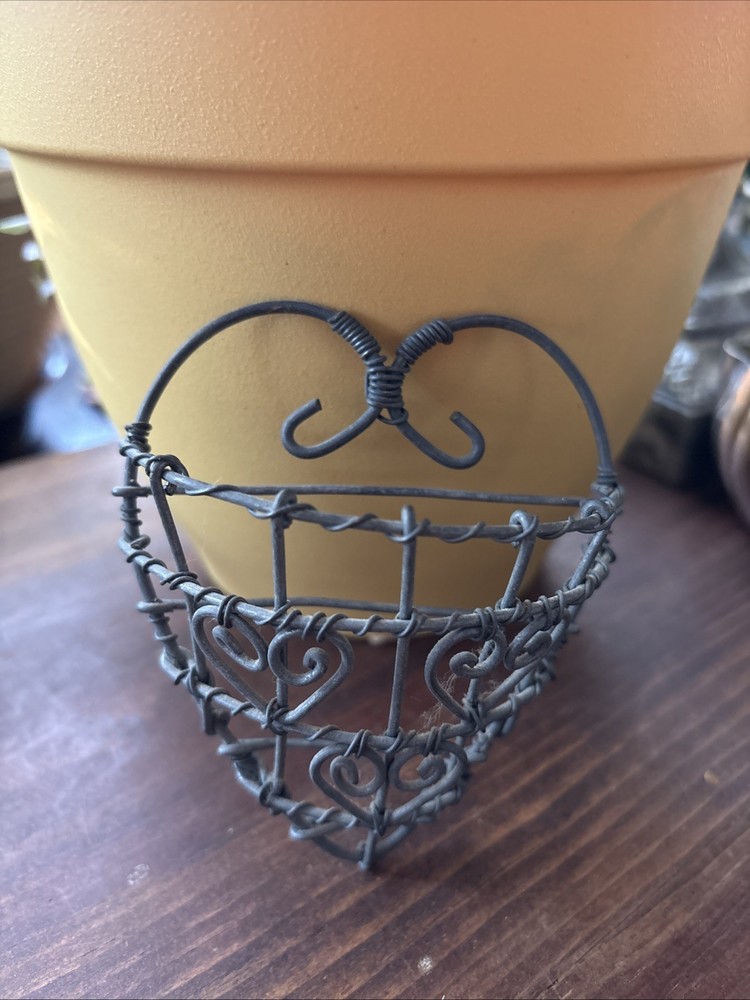 rustic, heart-shaped wire basket with scrollwork details.