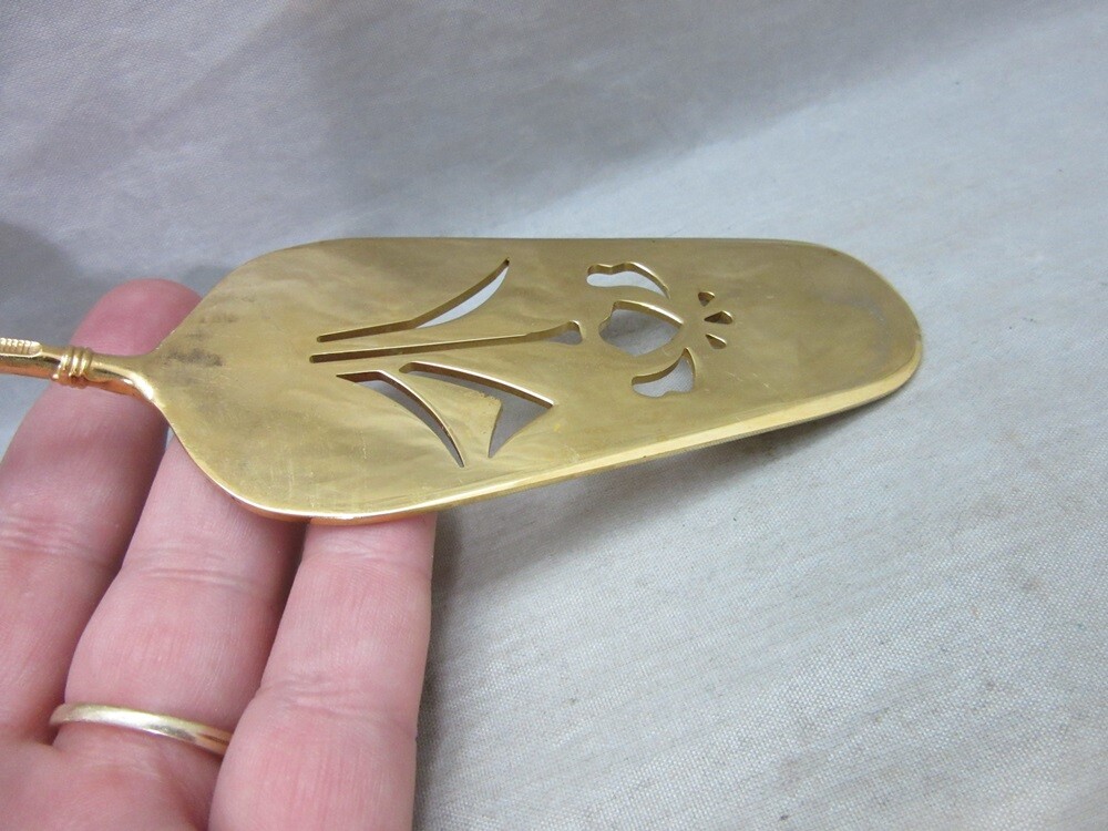 Gold plated cake server with red enamel handle