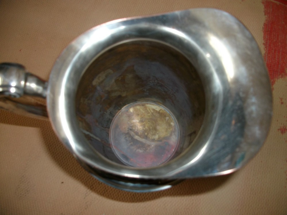 Silver water pitcher with round bottom