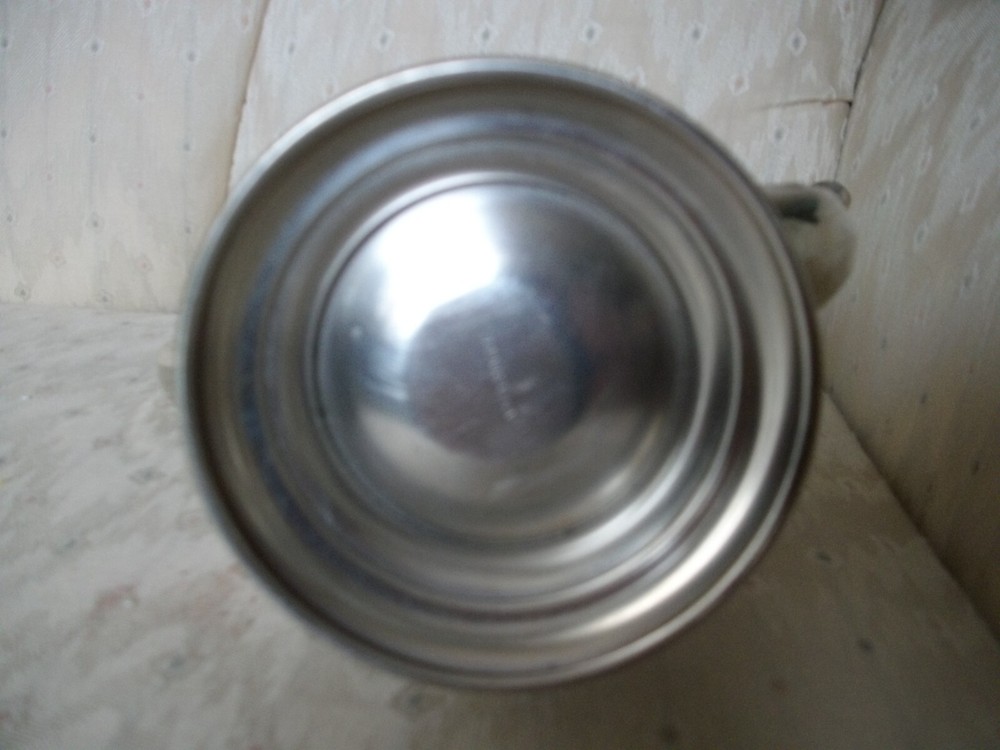 Silver coffee pot with insulated handle round bottom