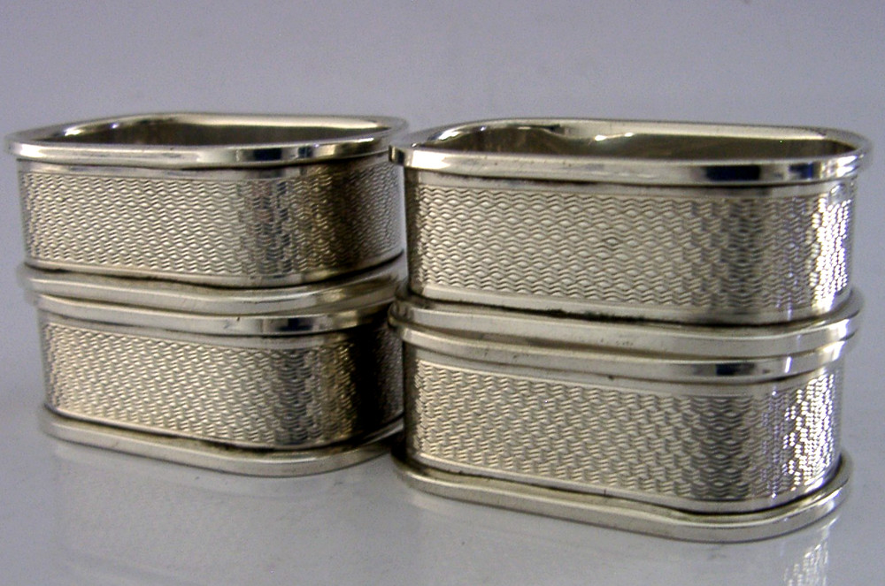 FOUR ENGLISH SOLID STERLING SILVER ENGINE TURNED NAPKIN RINGS 1959/60
