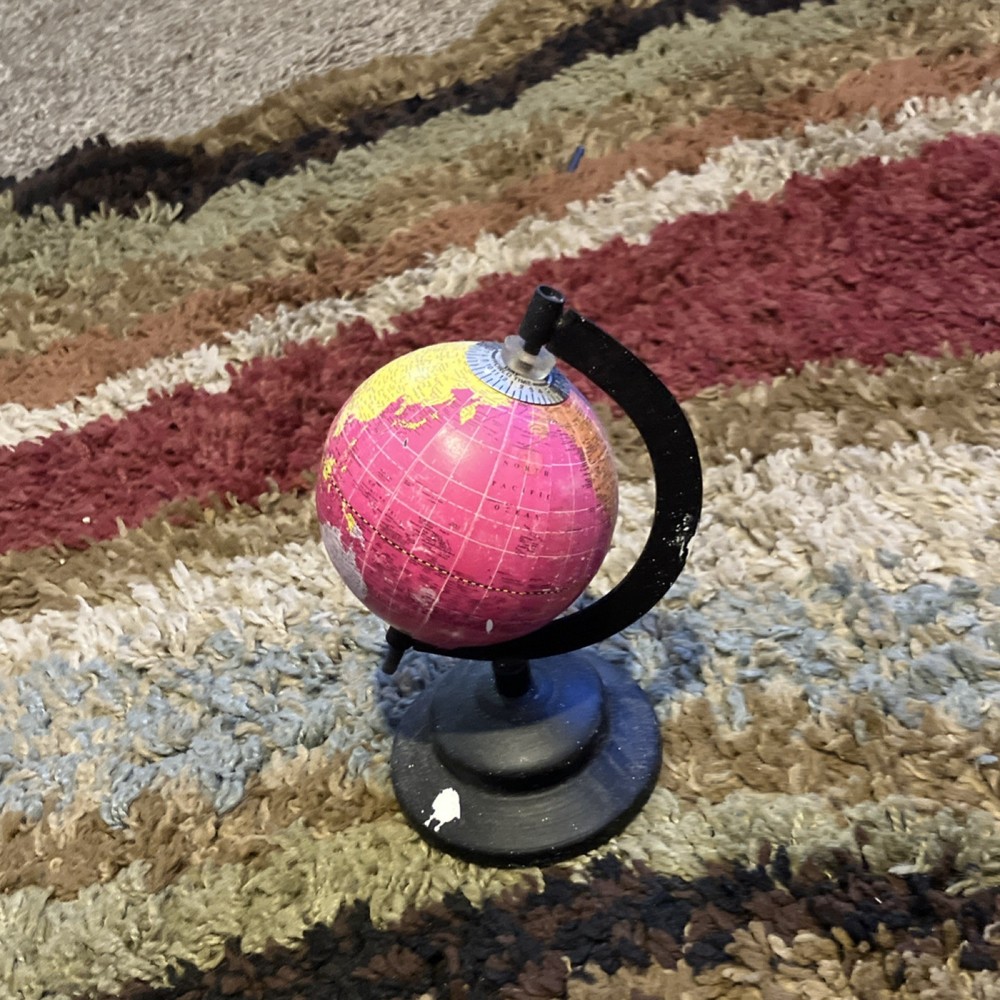 Small Decorative Pink and Yellow Tabletop Globe with Rotating Black Base