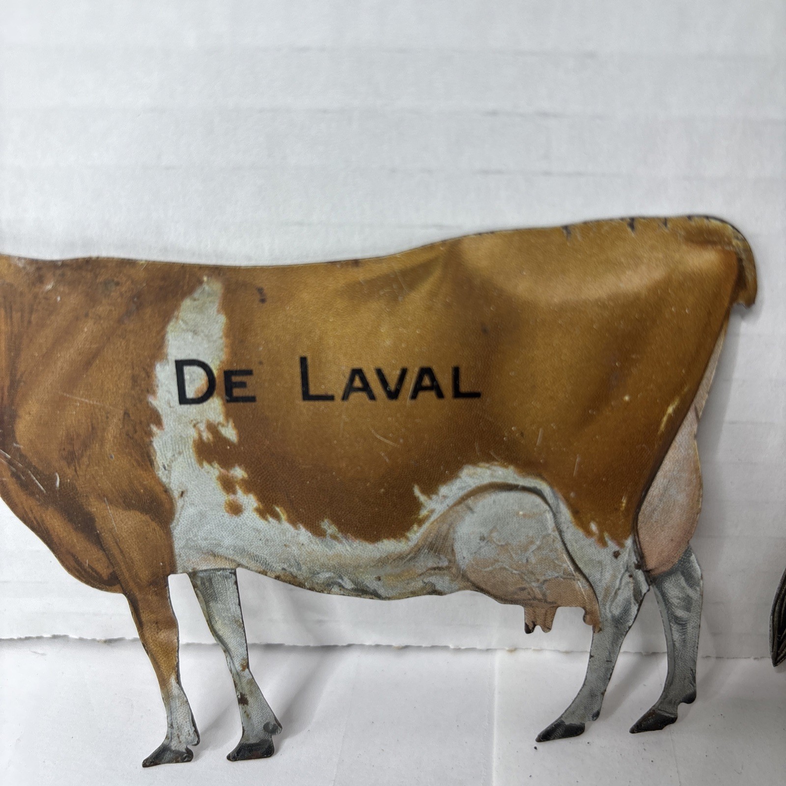 Pair of Antique DeLaval tin die cut cow and calf advertising cream separator ads