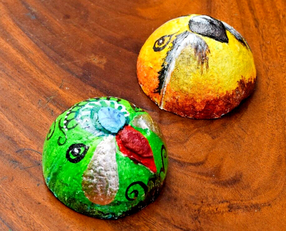 Coconut shells hand painted with different faces specified for hotel decorations