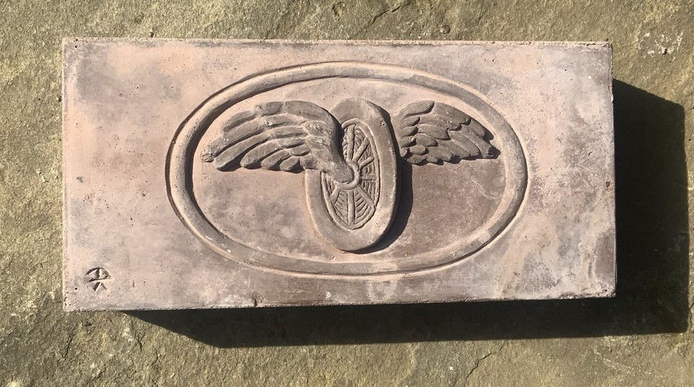 Brick With Winged Wheel Design