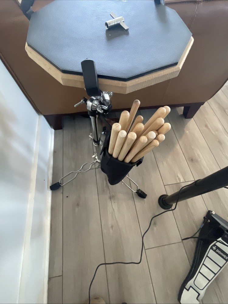 Donner DED-200 Drum set with amplifier, drumsticks, table, and seat.