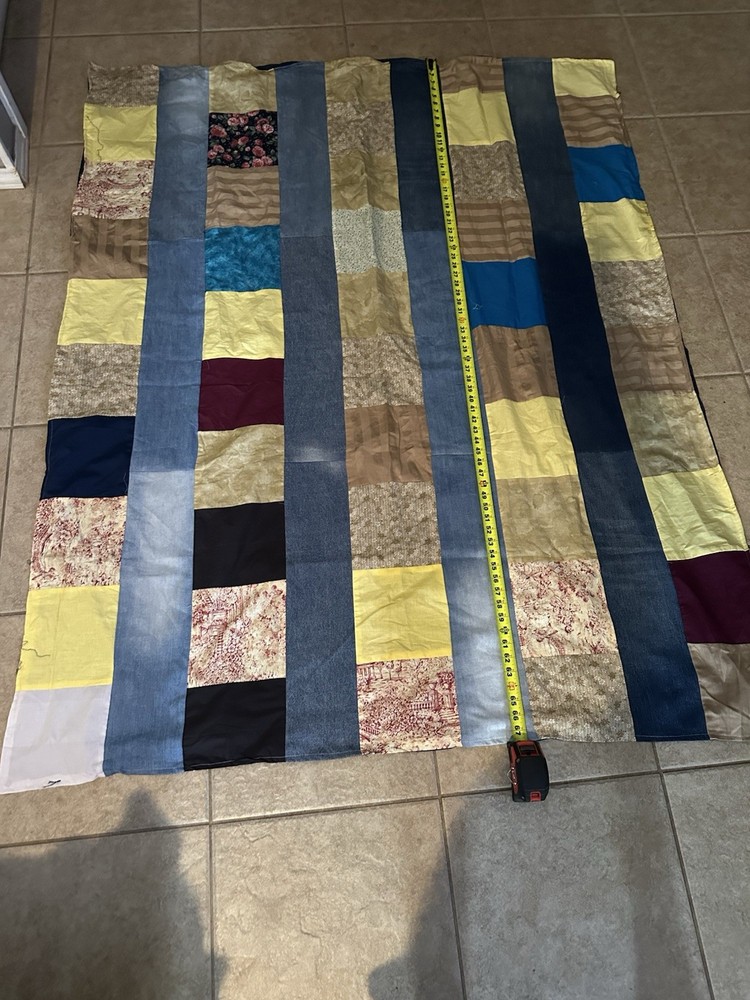 A handmade, multi-fabric strip-pieced quilt.