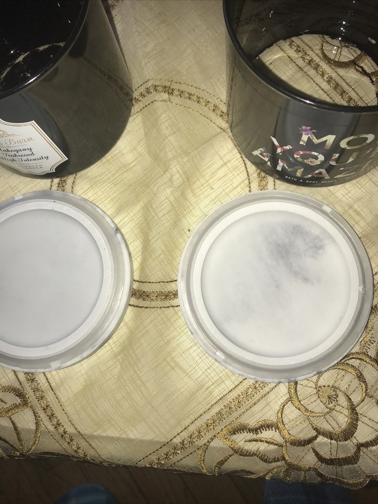 2 empty black candle jars with marble like lid