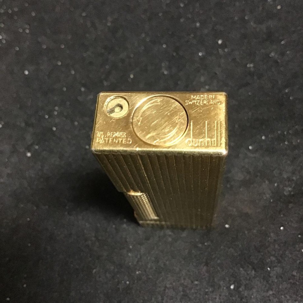 Overhauled gold dunhill lighter with striped pattern, ignition functioning well