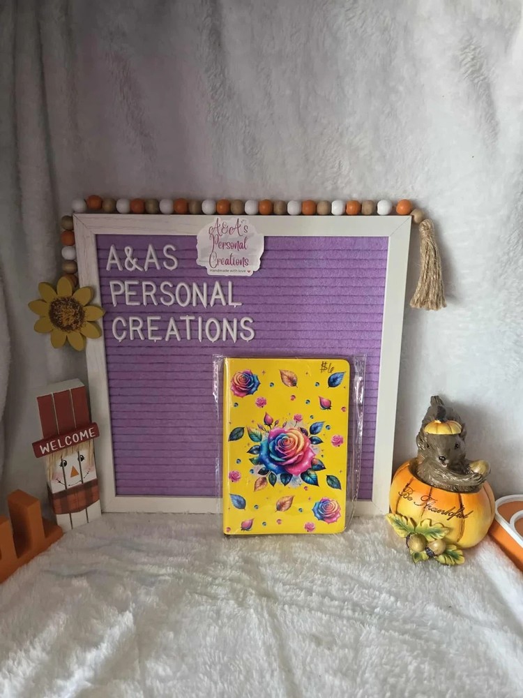 Rainbow rose on yellow notebook