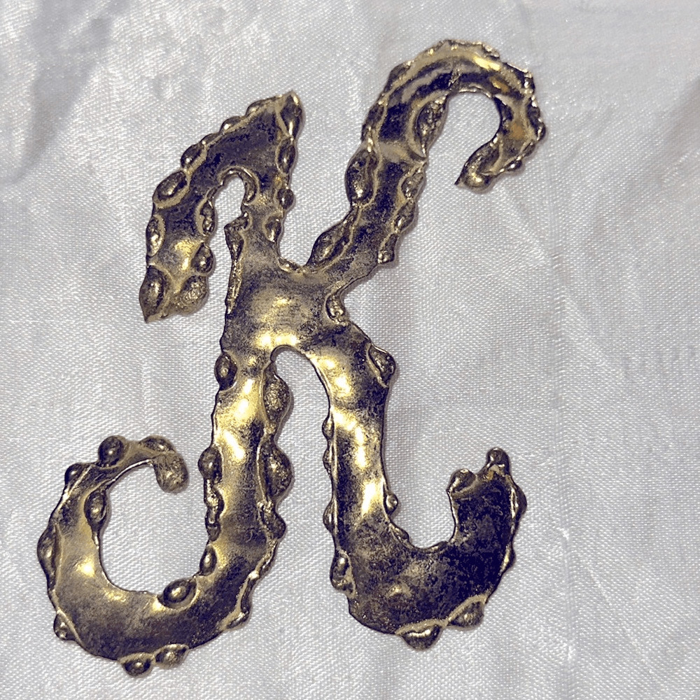 Vintage hammered brass K”