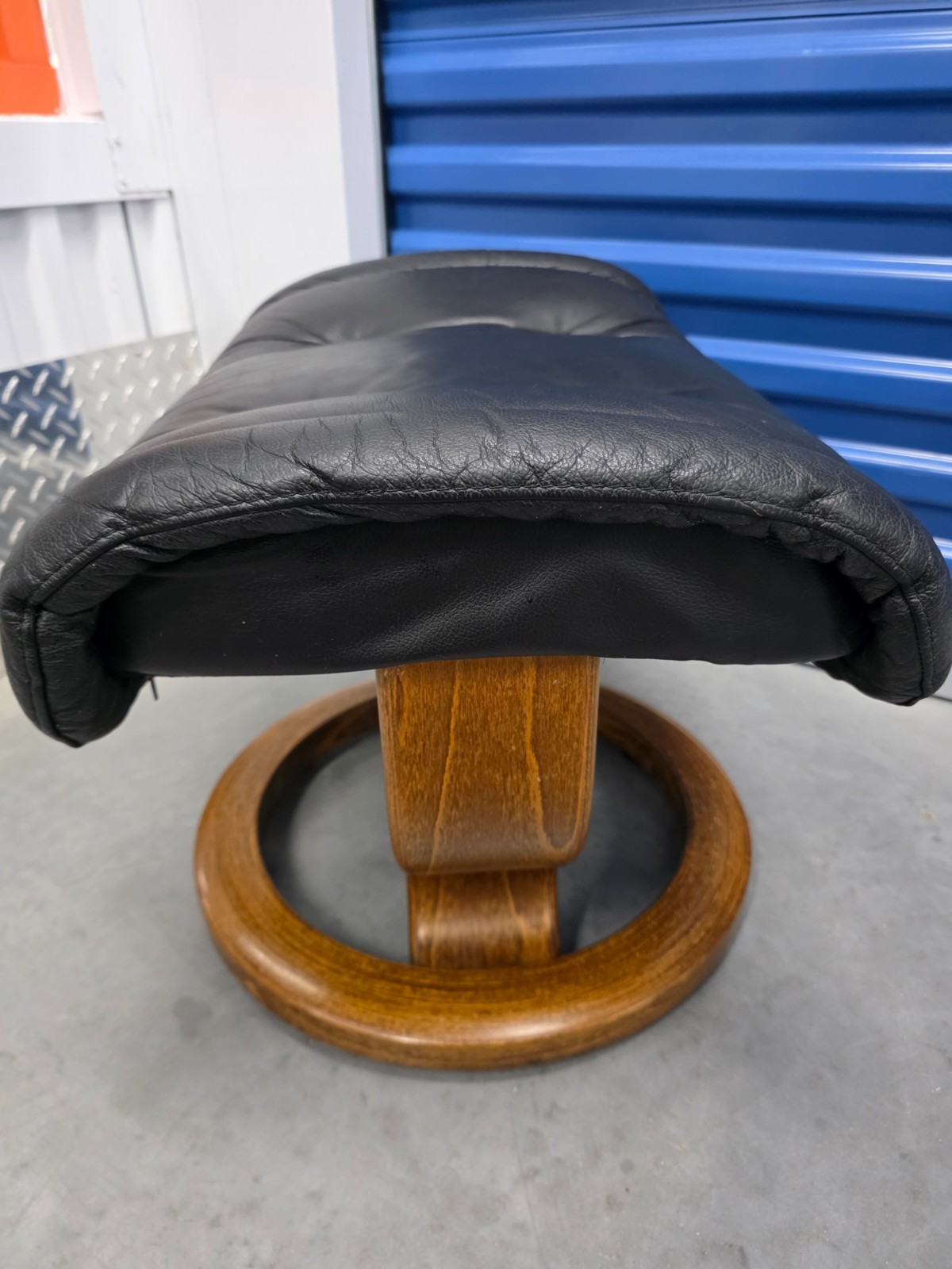 Ekornes Stressless Black Colored Leather Ottoman | Teak Stained Wood Base